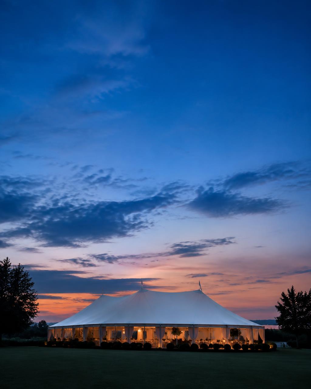 Gala marquee silhouette against a dusk sky